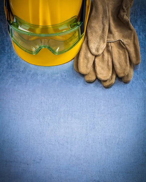 Gloves, building helmet and protective goggles