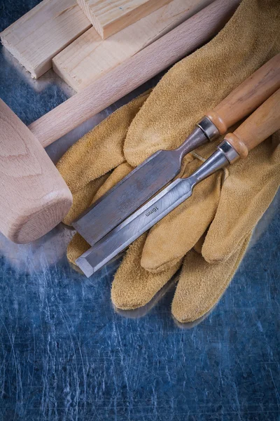 Wooden mallet, chisels and protective gloves