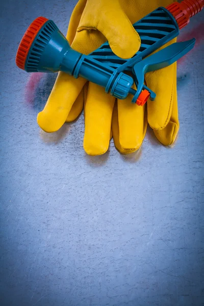 Protective gloves with hose spraying nozzle
