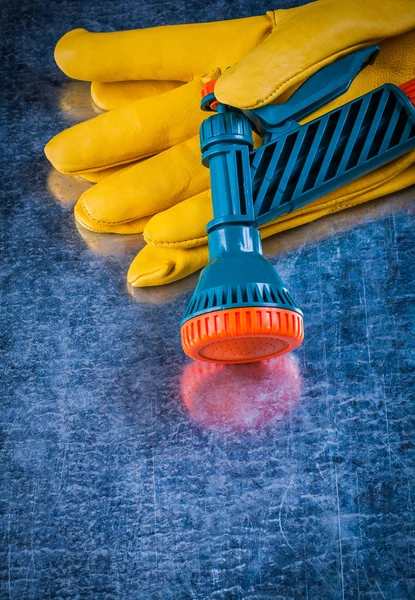Yellow gardening gloves and water sprayer