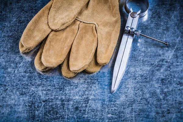 Leather safety gloves on metallic surface