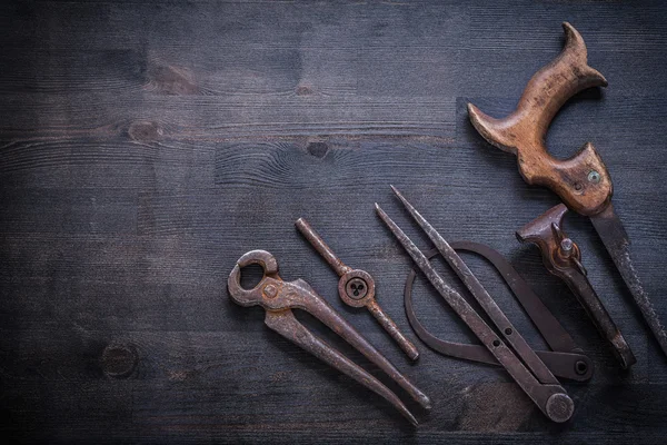 Vinatge rusted tools on dark board