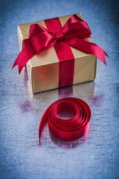 Present box with rolled red tape