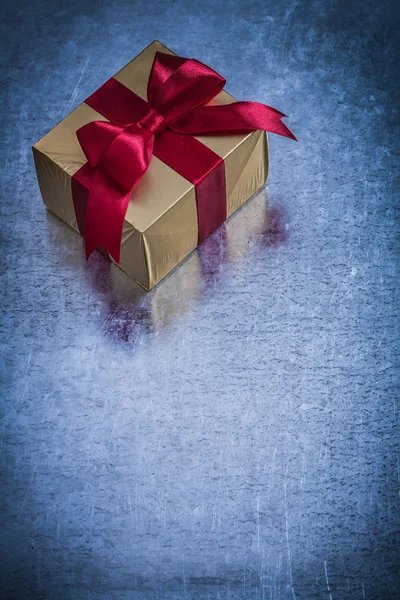 Gift box wrapped in golden paper