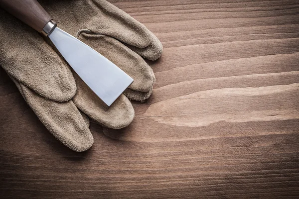 Paint scraper and working gloves