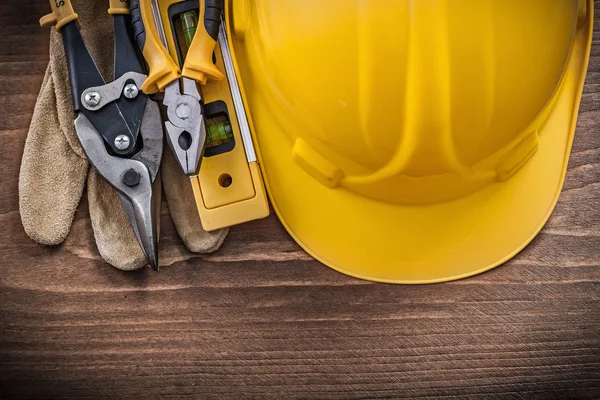 Pliers, construction level and safety gloves