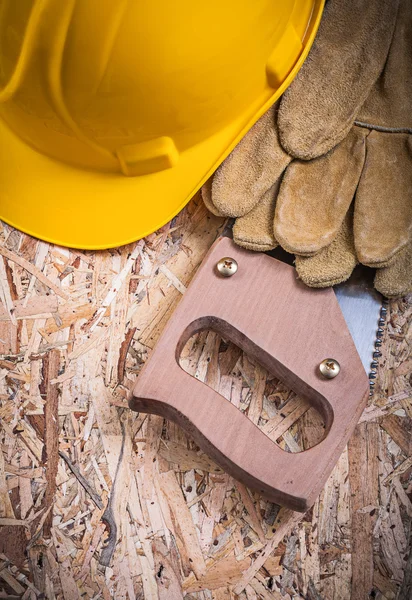 Safety gloves, building helmet and handsaw