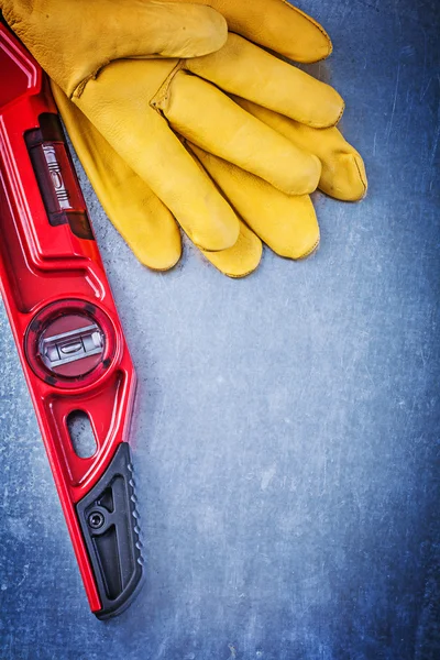 Construction level and protective gloves
