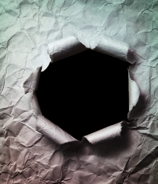 Crumpled Paper Background with Big Black Hole Punched Through