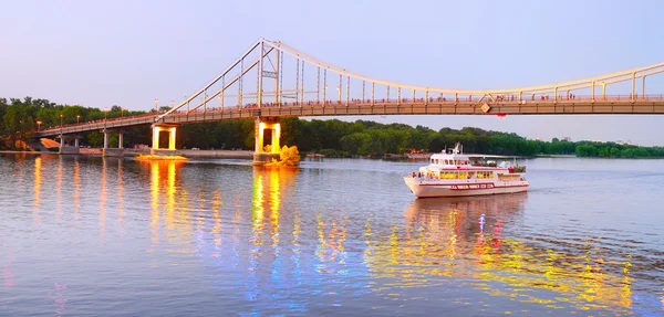 Pleasure boat under the Pedestrian bridge