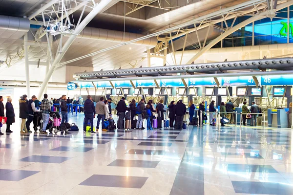 People in queue at check-in counter