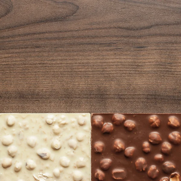 Different chocolate bars with whole hazelnuts