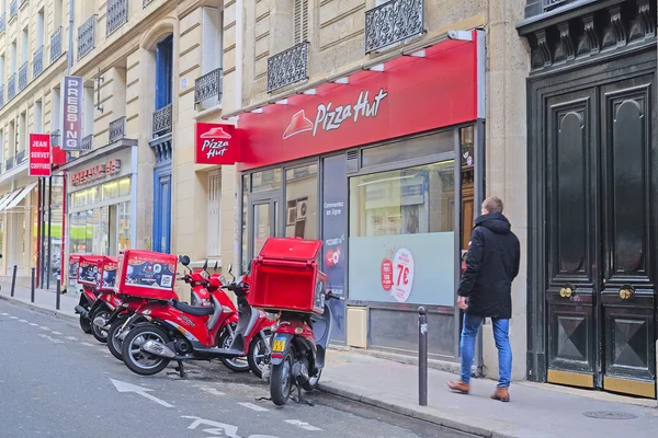 Motorcycle parking of pizza trucks in a center of Paris