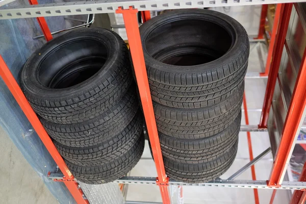 Car wheels stands on the shelves at the warehouse