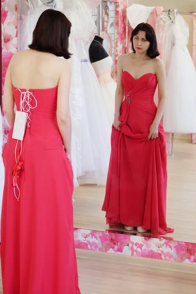 Woman tries on  wedding dress