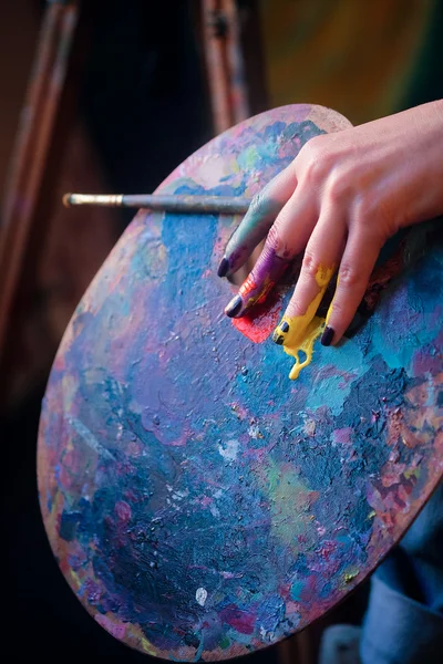 Artist\'s hand with the brushes