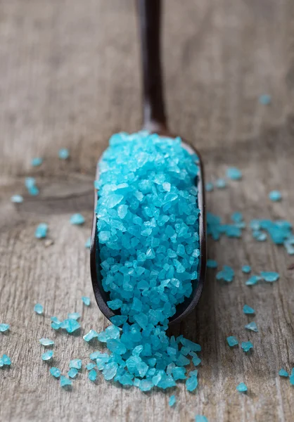 Light blue salt in a spoon.