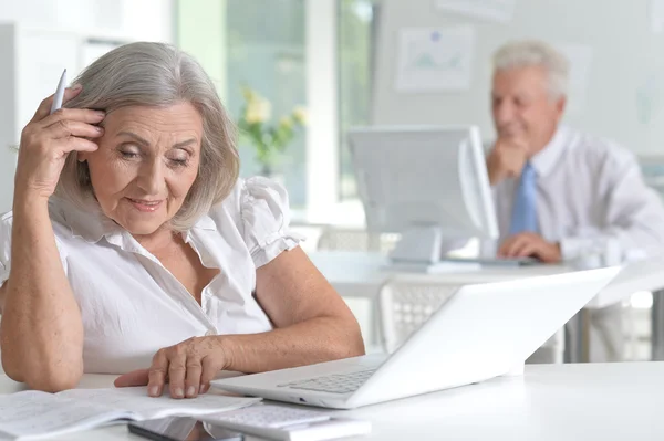 Mature man and woman working together