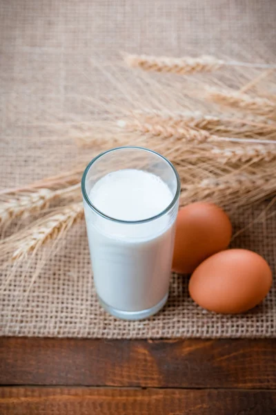 Glass of milk, eggs and wheat ears
