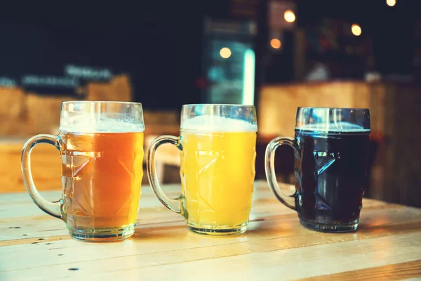 Beer on a wooden bar counter in pub