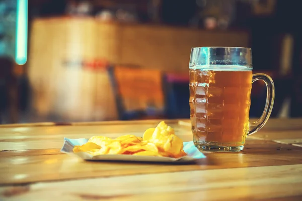 Beer on a wooden bar counter in pub