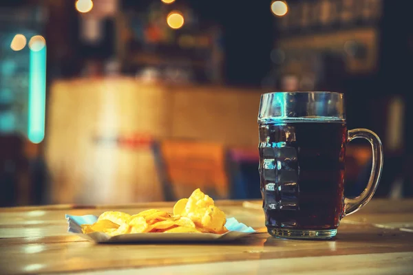 Beer on a wooden bar counter in pub