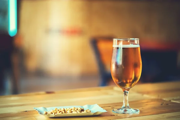 Beer on a wooden bar counter in pub