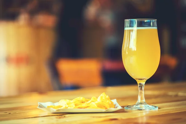 Beer on a wooden bar counter in pub