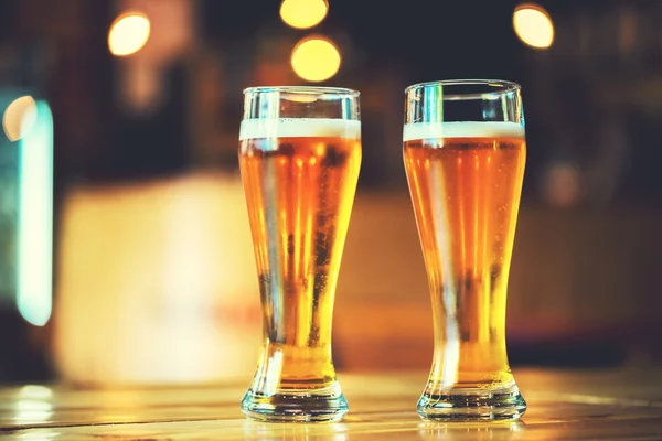 Beer on a wooden bar counter in pub