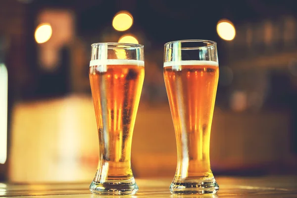 Beer on a wooden bar counter in pub