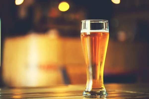 Beer on a wooden bar counter in pub