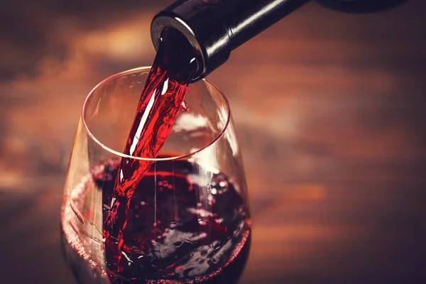 Pouring red wine into glass