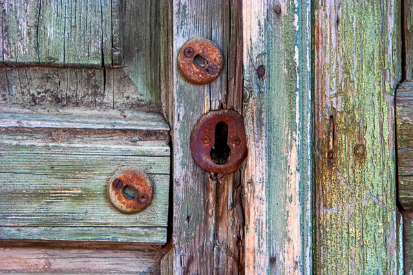 Old wooden door and rusty keyhole in Astrakhan, Russia