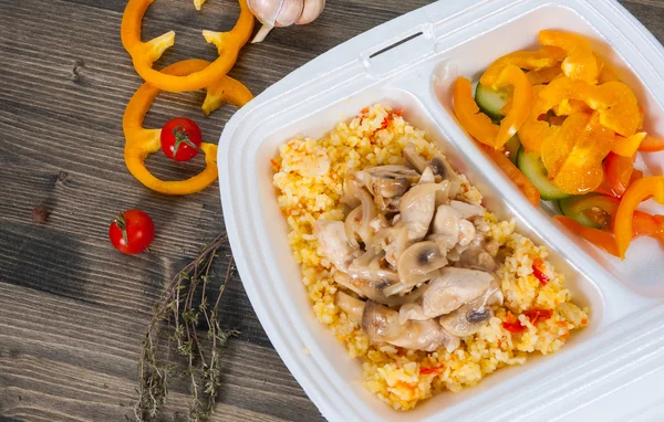 Rice with meat, vegetables, mushrooms and salad in lunch box