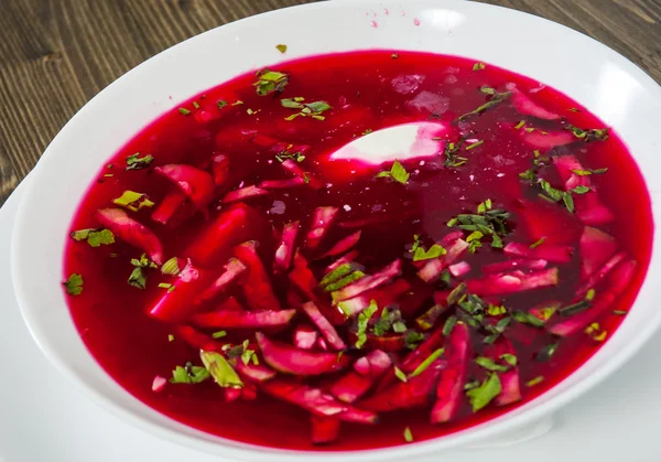 Vegetable cold soup with beet, cucumber, radsih and egg  on wooden table