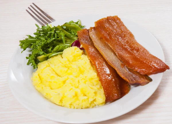 Smoked fish fillet with mashed potatoes and salad