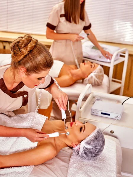 Group young woman receiving electric facial massage.