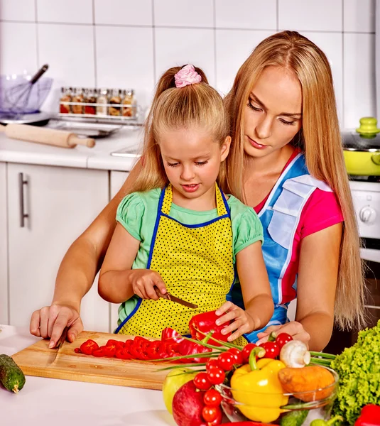 Mother and child cooking at kitchen.