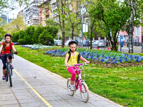 Bikes cycling girls with rucksack cycling on bike lane.