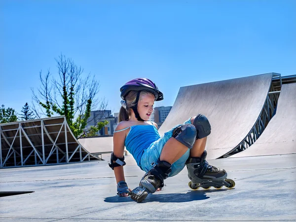 Girl riding on roller skates in skatepark.