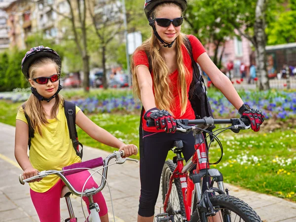 Bikes cycling girls with rucksack on bike lane.