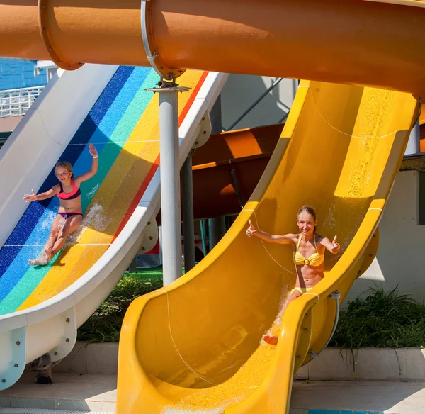 Children on water slide at aquapark.