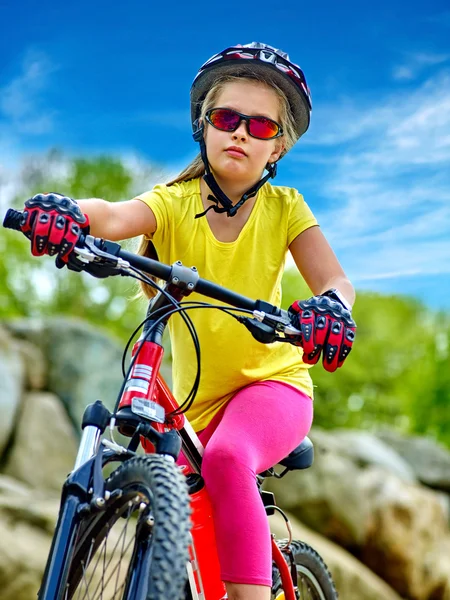 Bikes cycling girl into park rides bicycle on mountains.