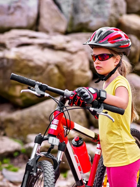 Bikes cycling girl in park rides bicycle into mountains.