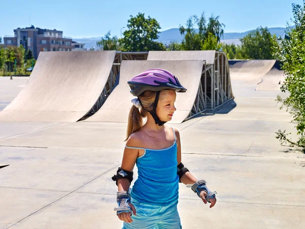 Girl riding on roller skates in skatepark. Outdoor.
