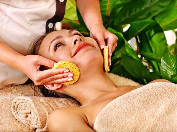 Woman getting facial massage .