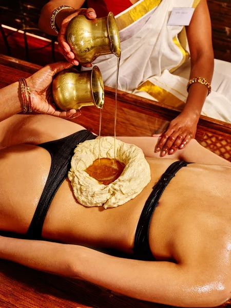 Woman having Ayurvedic spa treatment.