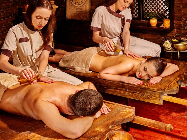 Couple having Ayurvedic spa treatment.