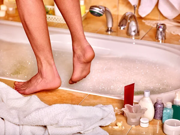 Woman wash leg in bathtube.