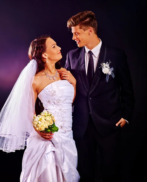 Couple wearing wedding dress and costume.